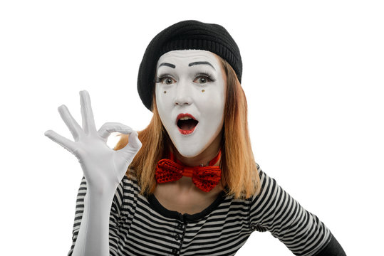 Female mime showing OK sign with open mouth