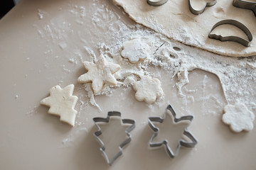 christmas spirit in the kitchen. top view photo. granny cooking biscuits for grandson, children