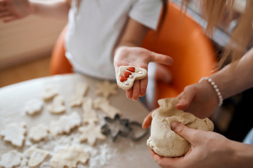 child showing decorated cke in her palm, close up cropped photo. surprise to father, daddy, pleasant gift, st. valentine, christmas time. close up cropped photo, blurred background