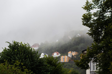Hillside homes at Floyfjellet on a rainy and foggy autumn day in Bergen Norway