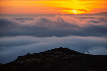  Dreamy misty landscape above the sea of clouds, mountains at sunset in Iceland