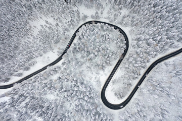 Top-down aerial drone shot of cars crossing in winter.