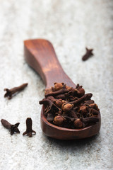 Cloves in wooden spoon macro image