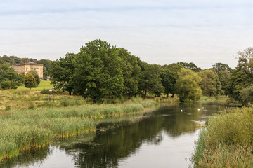 Fototapeta premium English rural landscape with River Dearne, in the Yorkshire Sculpture Park, near Wakefield in South Yorkshire.