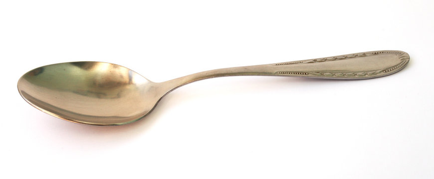 metal tablespoon on a white background close-up