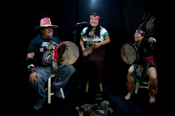 group of shaman Teotihuacanos, Xicalanca - Toltec in black background, with traditional dress dance with a trappings with feathers and drum