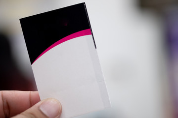 Hand holding cinema tickets.