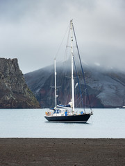 view to sail yacht in lagoon on volcanic island Deception in Antarctica