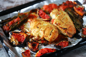 Baked chicken fillet with grapefruit and rosemary on a baking sheet. Keto, Paleo, Pegan, diet.