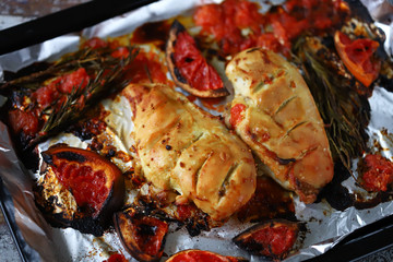Baked chicken fillet with grapefruit and rosemary on a baking sheet. Keto, Paleo, Pegan, diet.