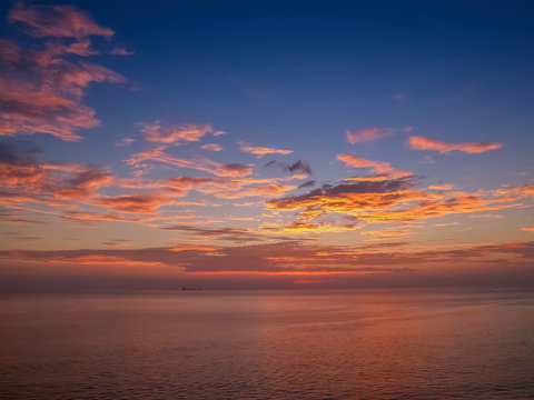 view seaside evening of many clouds moving above the sea with red sun light and cloudy sky background sunset at Tanod Cape (Laem Tanod), Mu Ko Lanta National Park, Lanta island, Krabi, south Thailand.