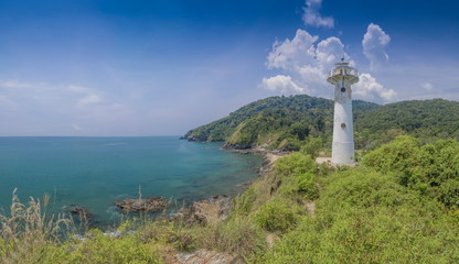 Fototapeta na wymiar view of lighthouse on top hill with blue-green sea, mountain and blue sky background, Laem Tanod (Tanod Cape), Mu Ko Lanta National Park, Lanta island, Krabi, southern of Thailand.
