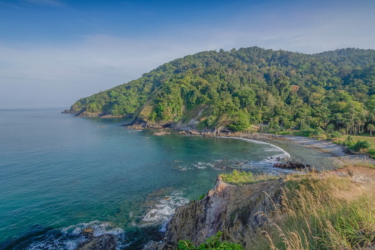 view curve of sand beach around with many rocks, green mountain and blue sky background, Laem Tanod (Tanod Cape), Mu Ko Lanta National Park, Lanta island, Krabi, southern of Thailand.