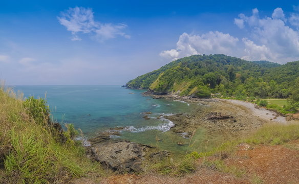 view curve of sand beach around with many rocks, green mountain and blue sky background, Laem Tanod (Tanod Cape), Mu Ko Lanta National Park, Lanta island, Krabi, southern of Thailand.