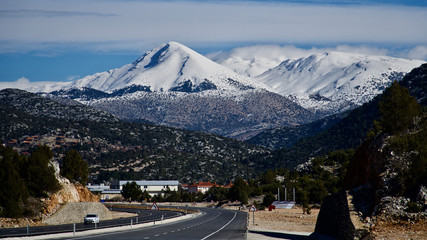 snowy mountain roads, blue sky and clouds