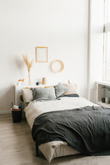 Bedroom interior in a Scandinavian minimalist style in white and gray colors