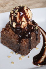 Chocolate brownie with vanilla ice cream ball above