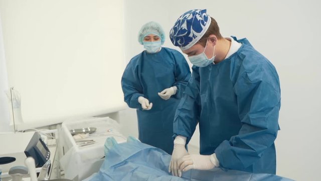 the young surgeon prepares the patient for surgery
