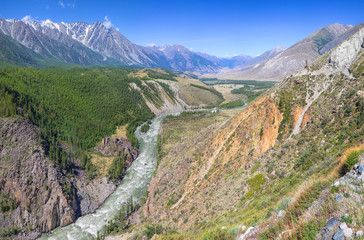 Above the mountain valley, the river flows among the mountains, Altai. Travel and vacation in the mountains.