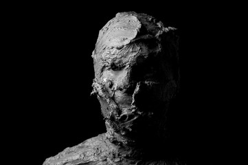 Fototapeta premium dramatic black and white portrait, shapeless face formed from torn pieces of clay