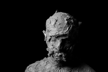 dramatic black and white portrait, shapeless face formed from torn pieces of clay