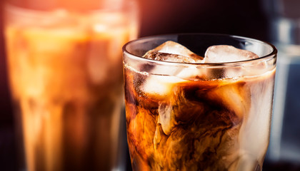 Coffee with ice and milk, brown table, selective focus and shallow DOF