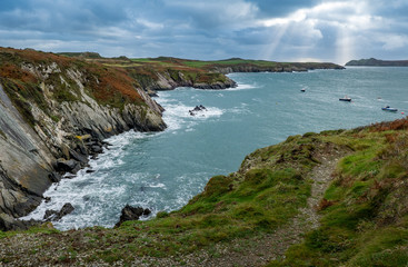 Shafts of light over a coastal landscape