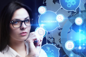 Business, Technology, Internet and network concept. Young businessman working on a virtual screen of the future and sees the inscription: Blockchain