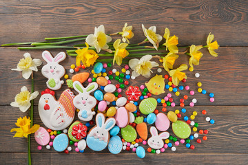 Easter glazed cookies and daffodils on table.