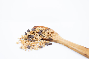 Wooden spoon with cereals on white background
