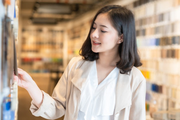 Architect or interior designer working with material sample board in showroom. Business of Real estate, home decoration .Creative people workplace.  young designer woman at office desk.