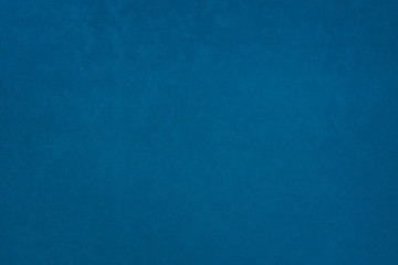 Textured wall background of dark matte blue colour