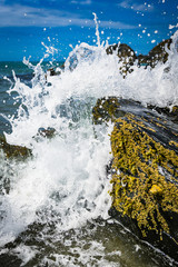 Water splashing against rock on a secluded beach