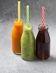 Various freshly squeezed fruits and vegetables juices. Vegetables and fruit smoothie in bottle, selective focus. 