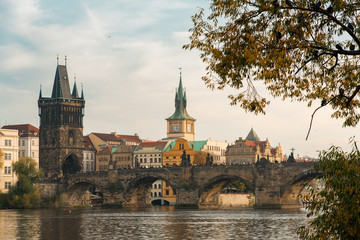 View of the Charles Bridge Through Autumn Leaves in Prague, Czechia