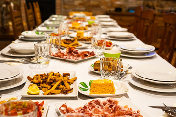 fried calamari with lemon, spanish cured ham, toast, pate, on the table
