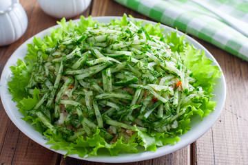 Norwegian salad salad of canned fish and fresh cucumber, selective focus