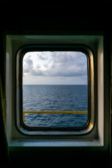 Looking out of window from a cabin of a construction work barge at oil field