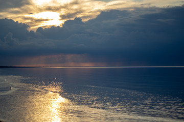 Sea ocean landscape at sunset with volumetric light (god rays) Baltic shore coast at dusk