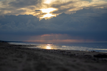 Sea ocean landscape at sunset with volumetric light (god rays) Baltic shore coast at dusk