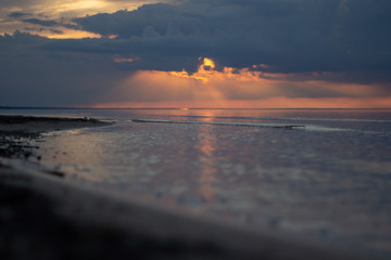 Sea ocean landscape at sunset with volumetric light (god rays) Baltic shore coast at dusk