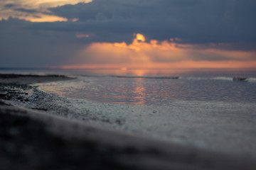 Sea ocean landscape at sunset with volumetric light (god rays) Baltic shore coast at dusk