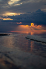 Sea ocean landscape at sunset with volumetric light (god rays) Baltic shore coast at dusk