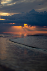 Sea ocean landscape at sunset with volumetric light (god rays) Baltic shore coast at dusk