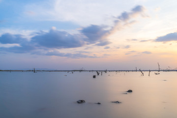 Double exposure shot of water with sky sunset time.