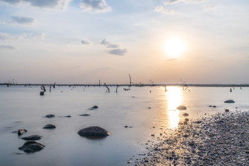 Naklejka premium Double exposure shot of water with sky sunset time.