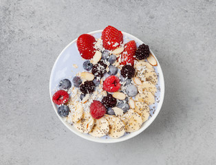 Healthy breakfast. Smoothie bowl with yogurt, blue water, banana, Chia, strawberries, raspberries, blueberries and almonds. Vegan food