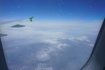 VIew of snow capped mountains from an airplane window