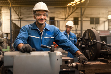 Technicians and engineers are working in a factory with modern machines. Twins Caucasian man Mechanical Engineer checking equipment in the industrial.