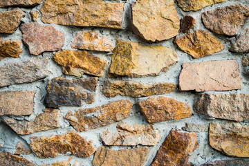 The texture of the old masonry. Background image of a stone-lined wall
